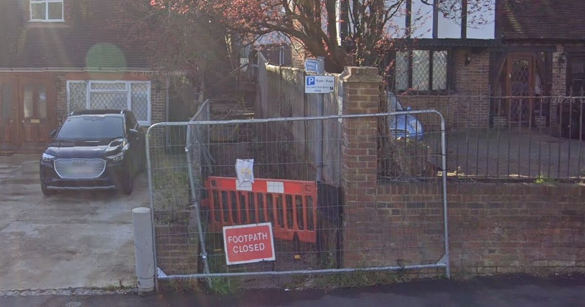 Warring neighbours call police after man blocks public footpath and refuses to let anyone near it