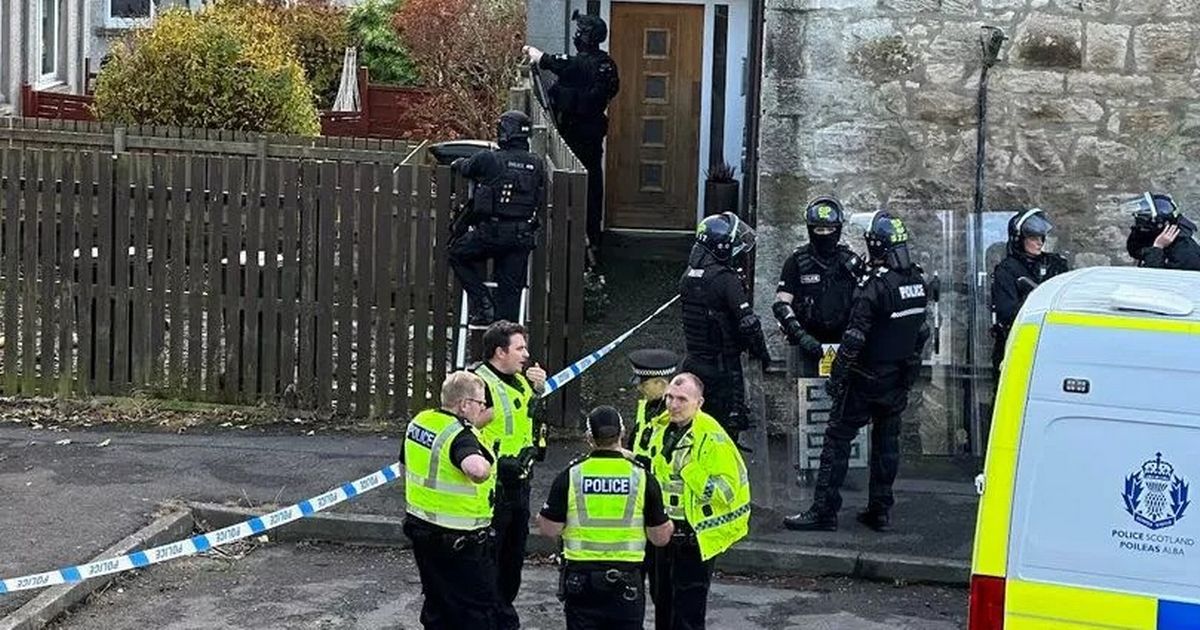 Police cordon off Kinross property after savage dog attack results in the death of a small dog and injuries to two others, alongside their owner